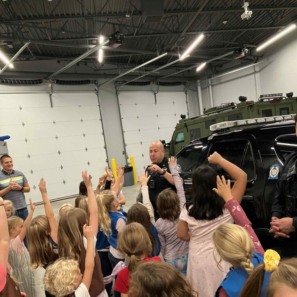 Police officer speaking to a group of young students