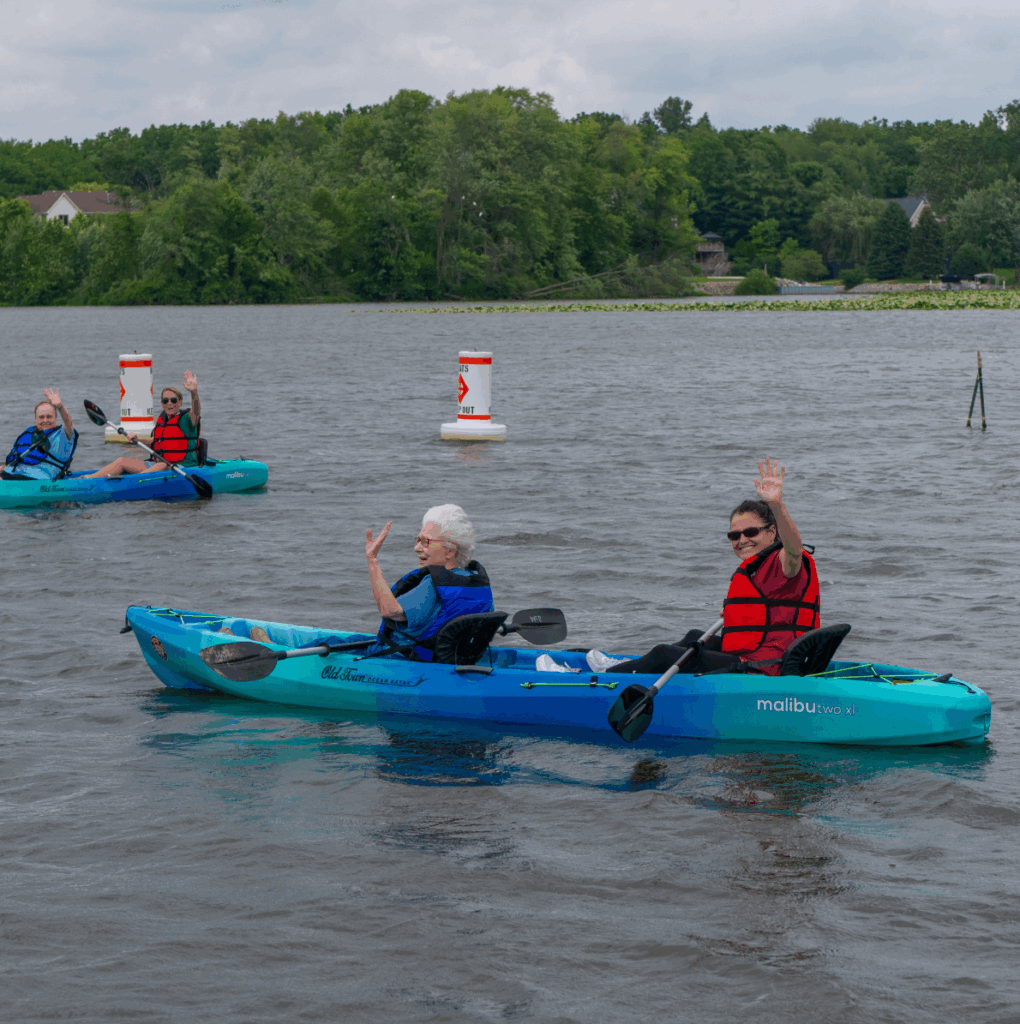 kayak people in kayaks on geist reservoir waving